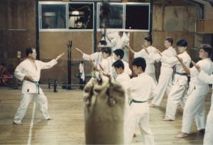 students learning from a sensei at the dojo