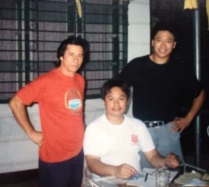 Romy Macapagal and two other men posing for a picture