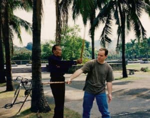 two men practicing marital arts outdoors